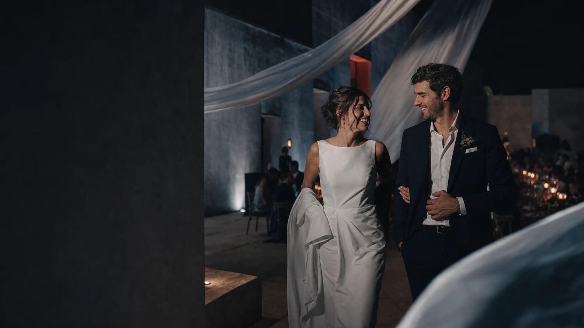 Pareja recién casada caminando durante una recepción nocturna